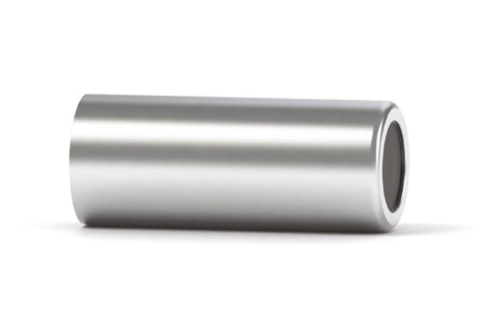Polished stainless steel hollow cylindrical spacer or bushing on white background