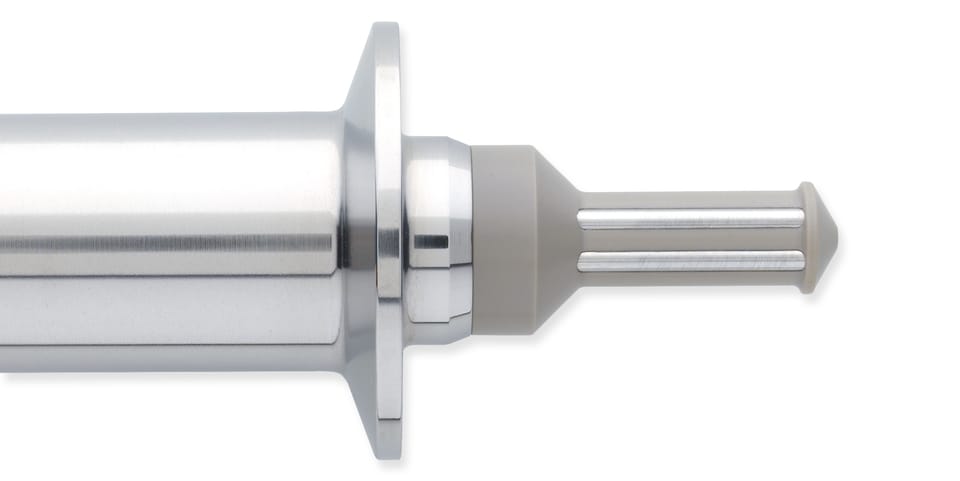 Close-up of a stainless steel tri-clamp sensor fitting with a slotted probe tip